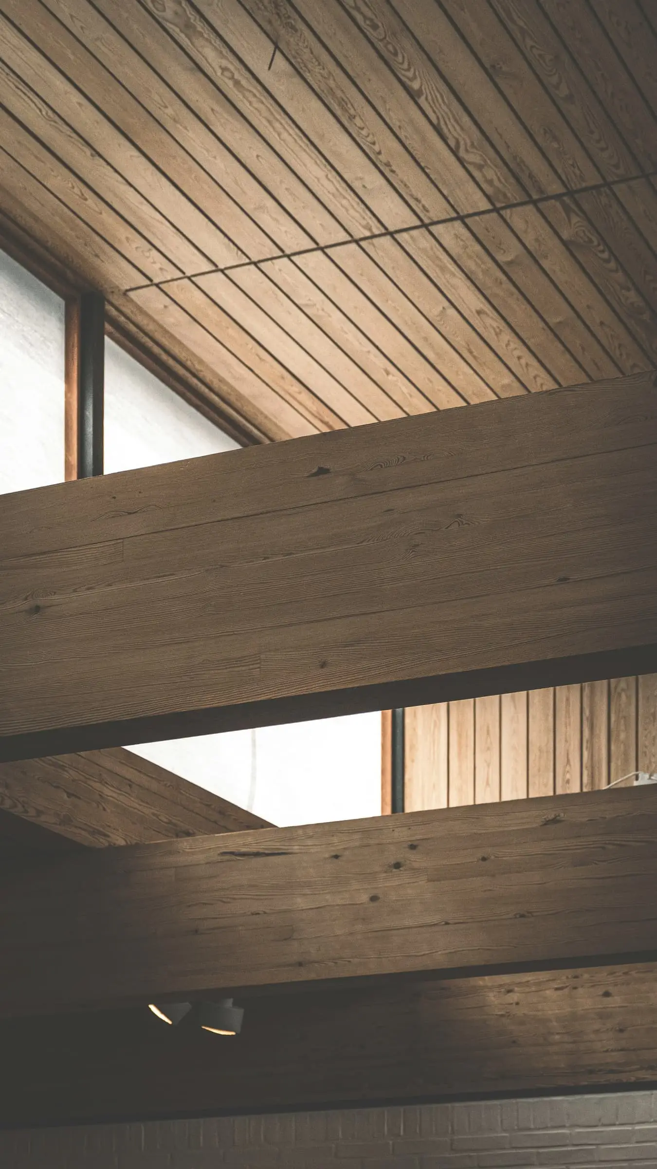 An oak-lined ceiling opening up to a narrow rooflight.